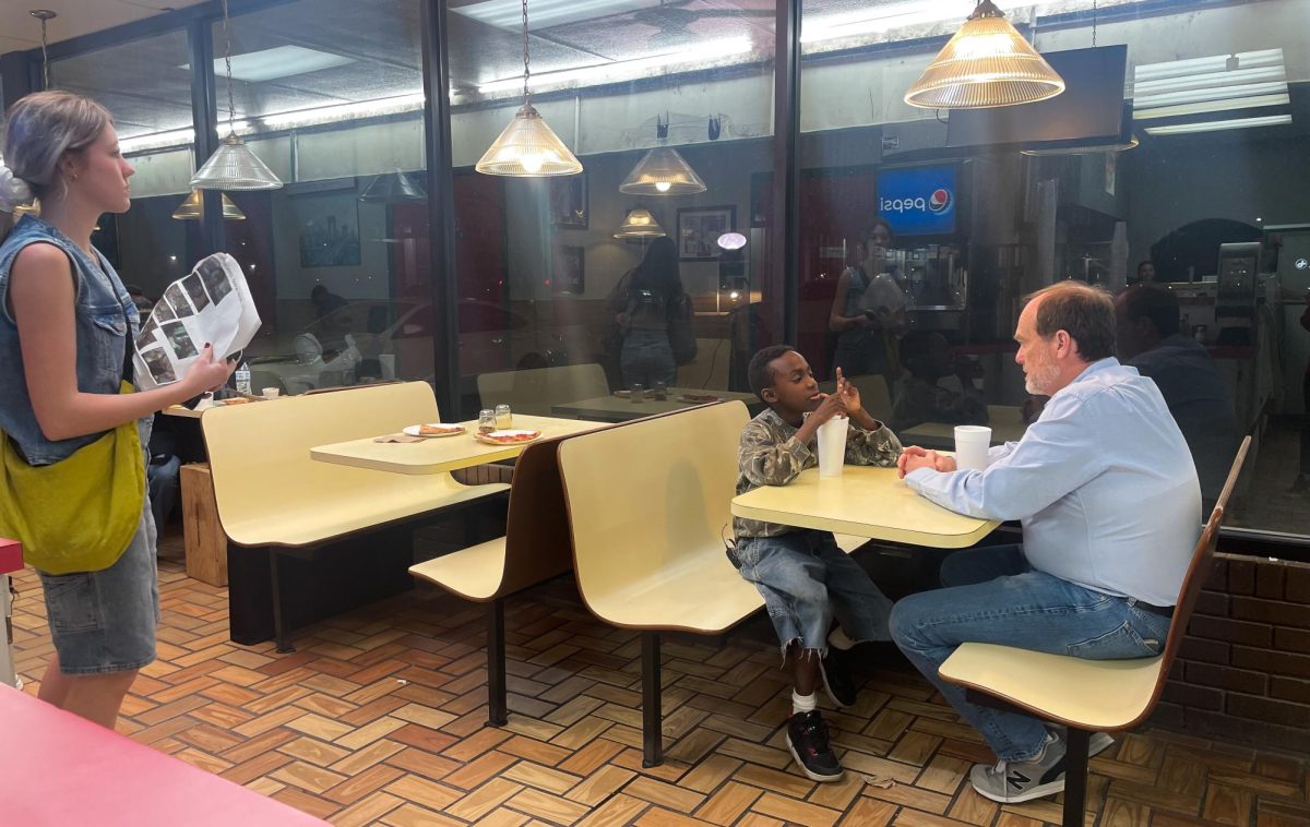 Junior Kyrsten Dalton (left to right) directs actors Patrick Bippus and Kurt Harris while shooting a scene at NYC Pizza for a short film for Oral Roberts University’s Media Mastery Institute.