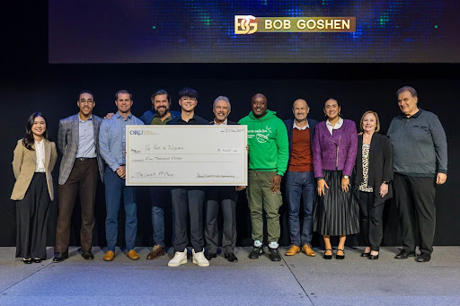 Daniel Kringel, winner of The Launch, holds his $5,000 prize. “The next step is to follow wherever God leads,” he says. Others, from left to right, include Aiko Gunawan, Enactus President; Isaiah Sparkman, Director Stovall Center for Entrepreneurship; Chris Hartshorn, Judge. Management Consultant at Hartshorn Financial; Alex Golimbievsky, Judge. Consultant at Alex Golimbievsky; Rick Fenimore, Judge. President and Co-founder of Trinity Chemical Industries; Kyle Smith, Judge. Partner Relationship Manager with Builders and Backers; Dr. Kevin Schneider, Executive Director Stovall Center for Entrepreneurship; Alejandrina Caamal, Project Coordinator Stovall Center for Entrepreneurship; Crystal Stovall, Wife of Jim Stovall and Board of Directors of the Tulsa Ballet; and Jim Stovall, Donator and active supporter of the Stovall Center for Entrepreneurship Jim is the founder of Narrative Television Network. 
